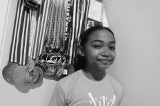 Junior gymnast Averyl Baline Mattahati, better known as Ave, poses with her medals.  JP/Toto Santiko Budi