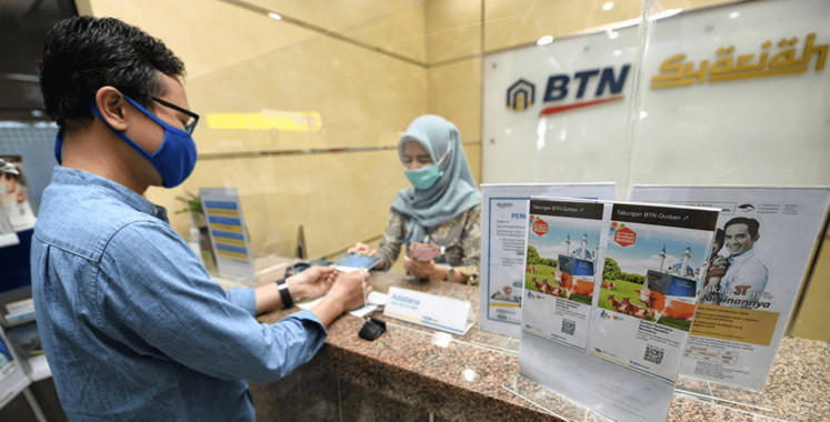 A customer conducts a transaction at a BTN Syariah branch in an undated photo.