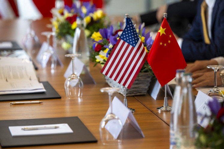 A handout photograph released by the Swiss Federal Department of Foreign Affairs on May 14, 2025, shows US and Chinese flags prior to bilateral meeting to discuss trade relations and tariffs, in Geneva, on May 10, 2025.