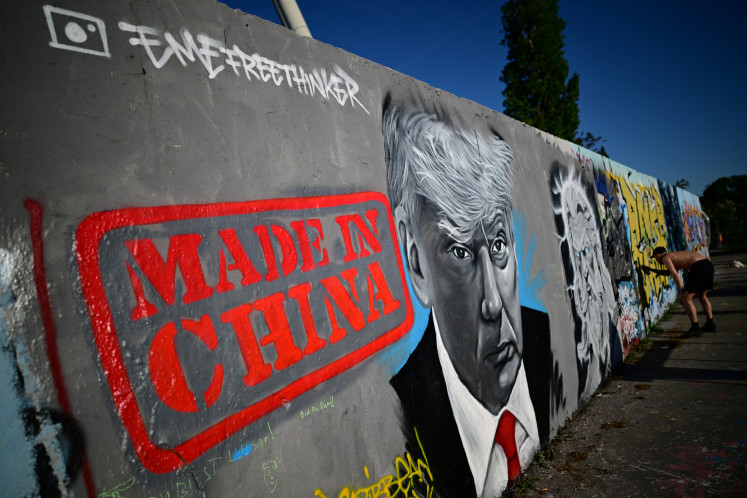 A mural by Berlin-based graffitti artist Eme Freethinker of United States President Donald Trump and lettering reading 'Made in China' is pictured on a wall at the Mauerpark public park in Berlin, Germany on April 26. 