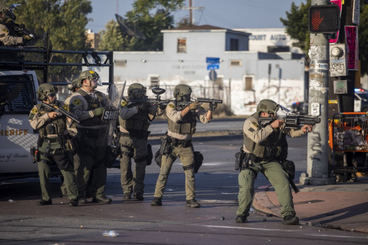 Law enforcement confronts demonstrators during a protest following federal immigration operations, in the Compton neighborhood of Los Angeles, California on June 7, 2025.