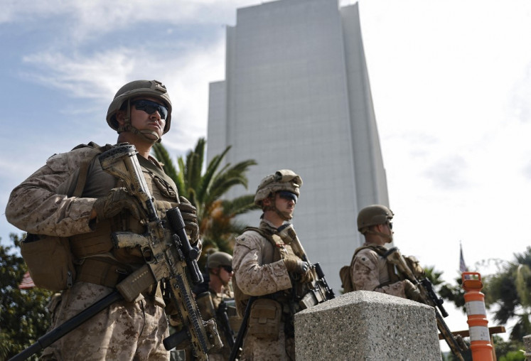 United States Marines personnel stand guard at an entrance to the Wilshire Federal Building on June 13, 2025 in Los Angeles, California, the US. A federal appeals court ruled on June 12 that the Trump administration can maintain control of the California National Guard, overturning a lower court ruling that US President Donald Trump's deployment of the troops to protest-laden Los Angeles without Governor Gavin Newsom's consent was unlawful.